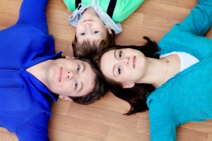 Mom, dad and child laying on floor