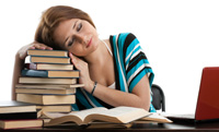 College woman resting her head on a pile of books